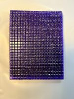 Full sheet of purple pyramid buy LSD gel tabs infused with sparkling gold flakes laid out on a clean surface