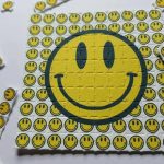 Grid of perforated cotton buy LSD blotter paper tabs printed with vibrant visionary artwork on a clean laboratory surface